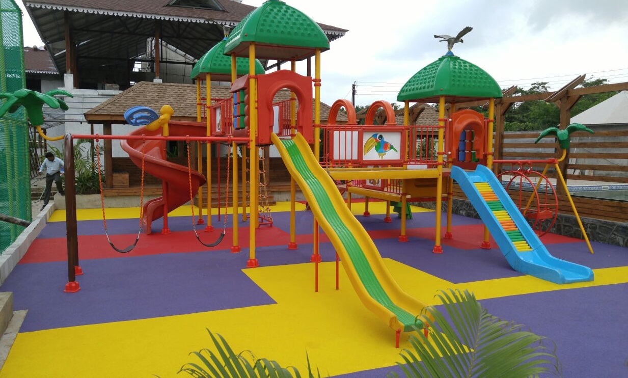 A vibrant children's play area with a slide and swings.